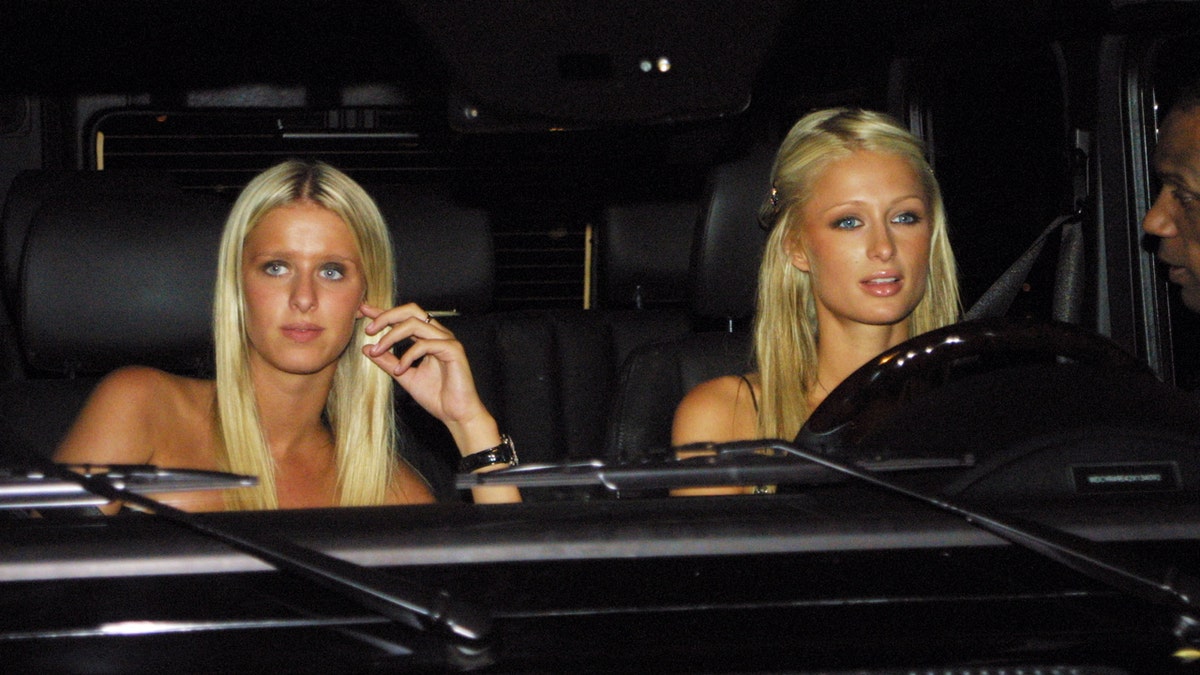 Nicky Hilton and Paris Hilton in a car shot by paparazzi