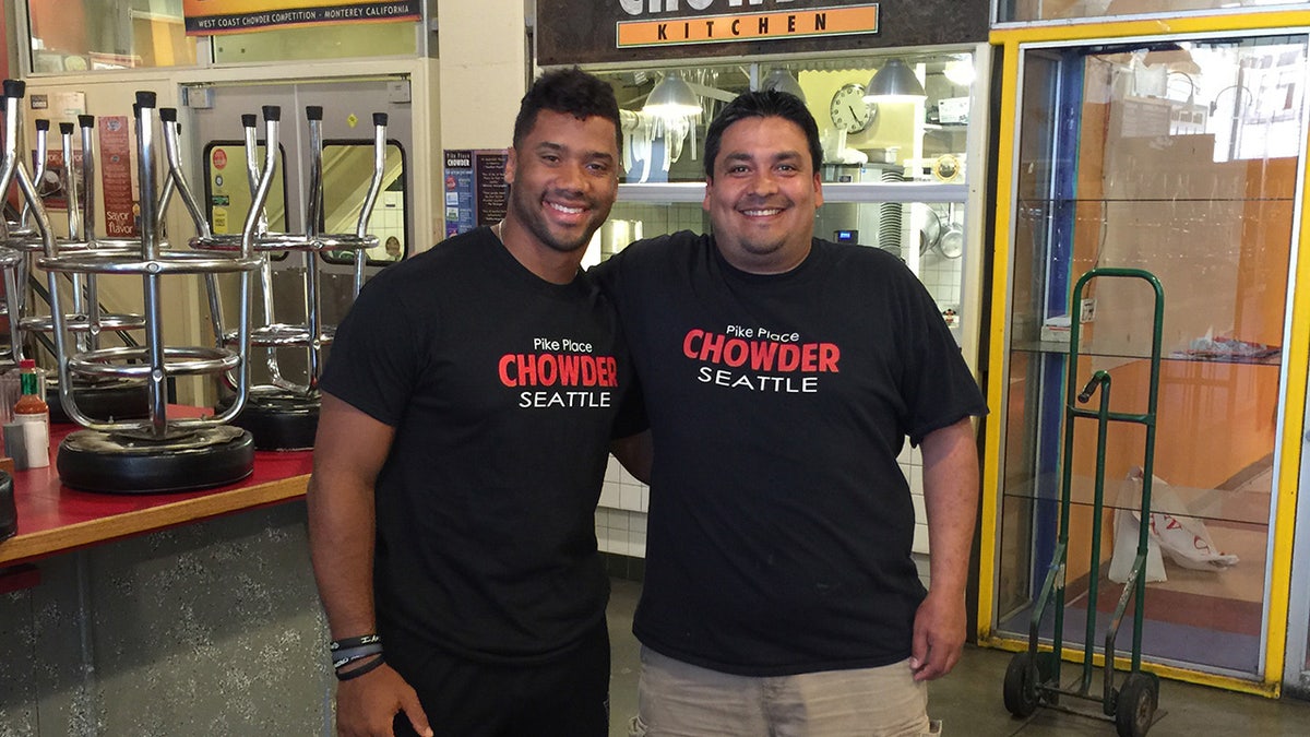 Russell Wilson and Dario, an employee at Pike Place Chowder.