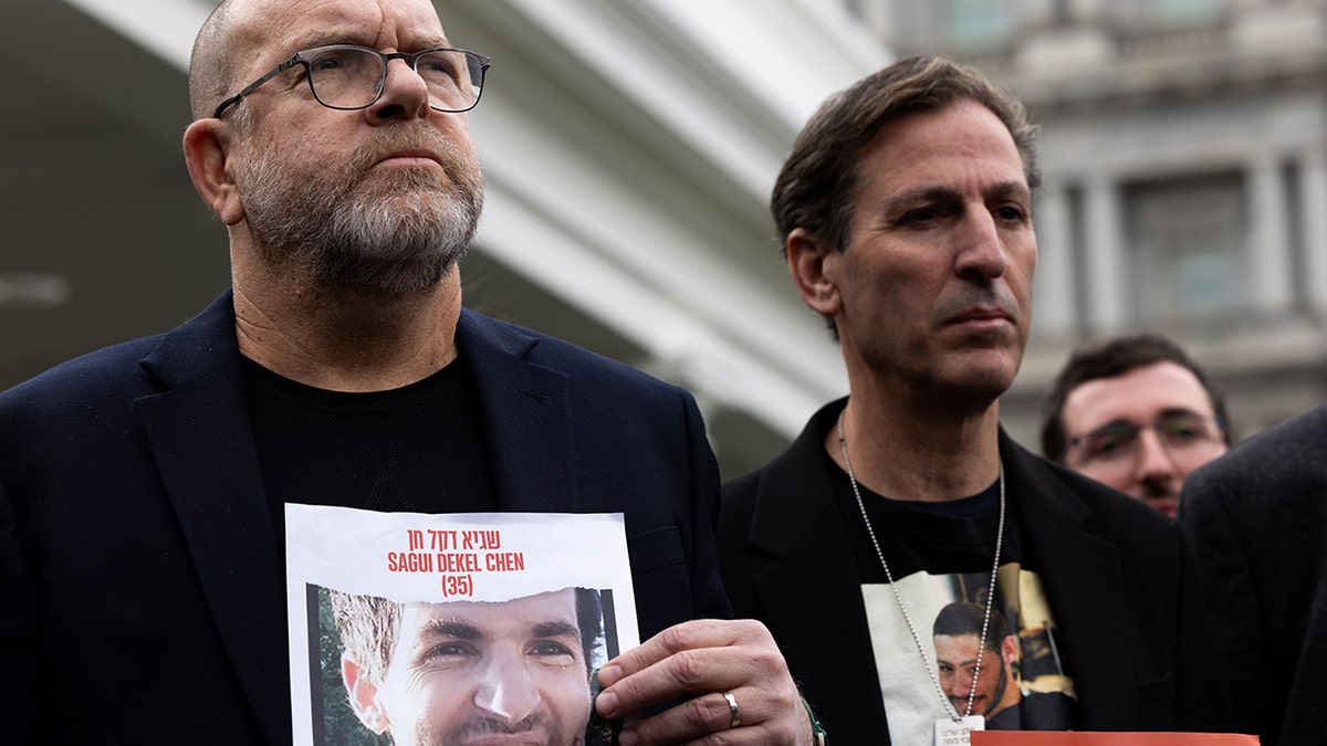 Surrounded by other family members of Americans who were taken hostage by Hamas during the Oct. 7 terrorist attacks in Israel, Jonathan Dekel-Chen, father of Sagui Dekel-Chen, and Ruby Chen, father of Itay Chen, speak to reporters after a meeting with President Biden at the White House on Dec. 13, 2023.