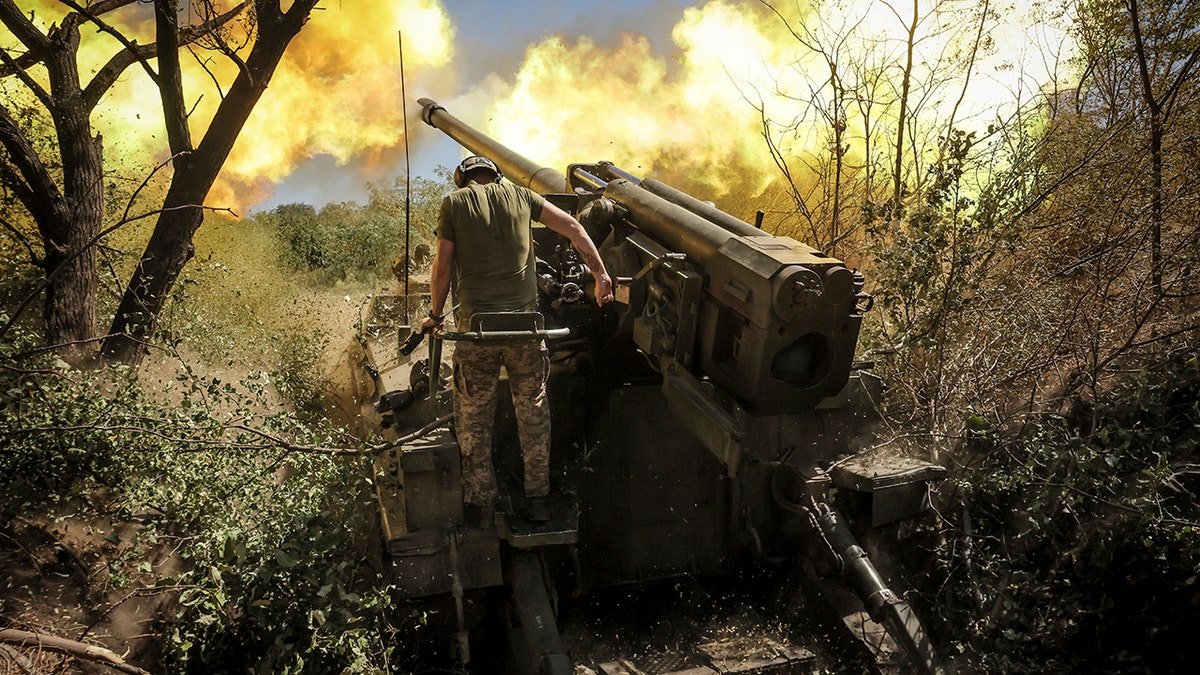 Servicemen of the 24th Mechanised Brigade fire a 