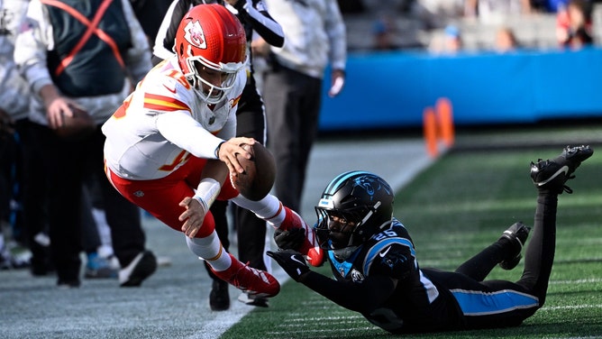 Kansas City Chiefs QB Patrick Mahomes reaches for the first town vs. the Carolina Panthers at Bank of America Stadium. (Bob Donnan-Imagn Images)