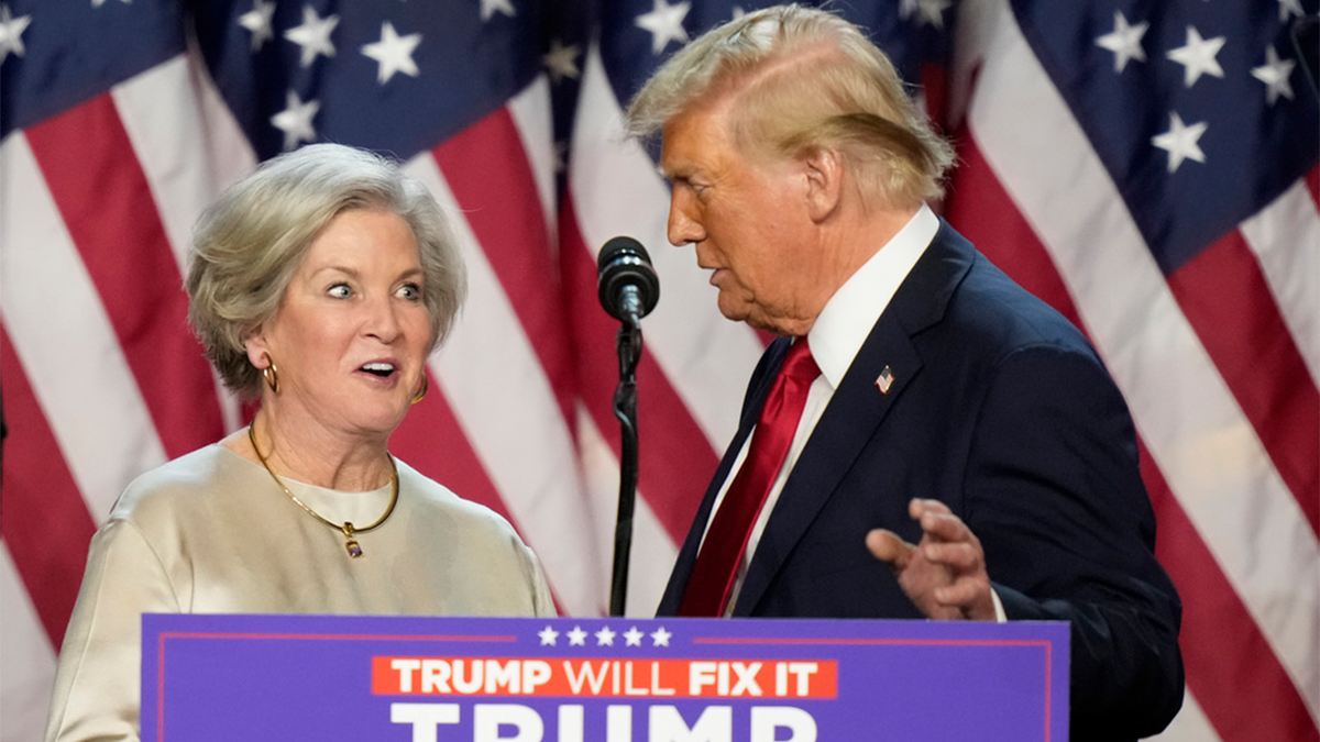 Susie Wiles on stage with Donald Trump