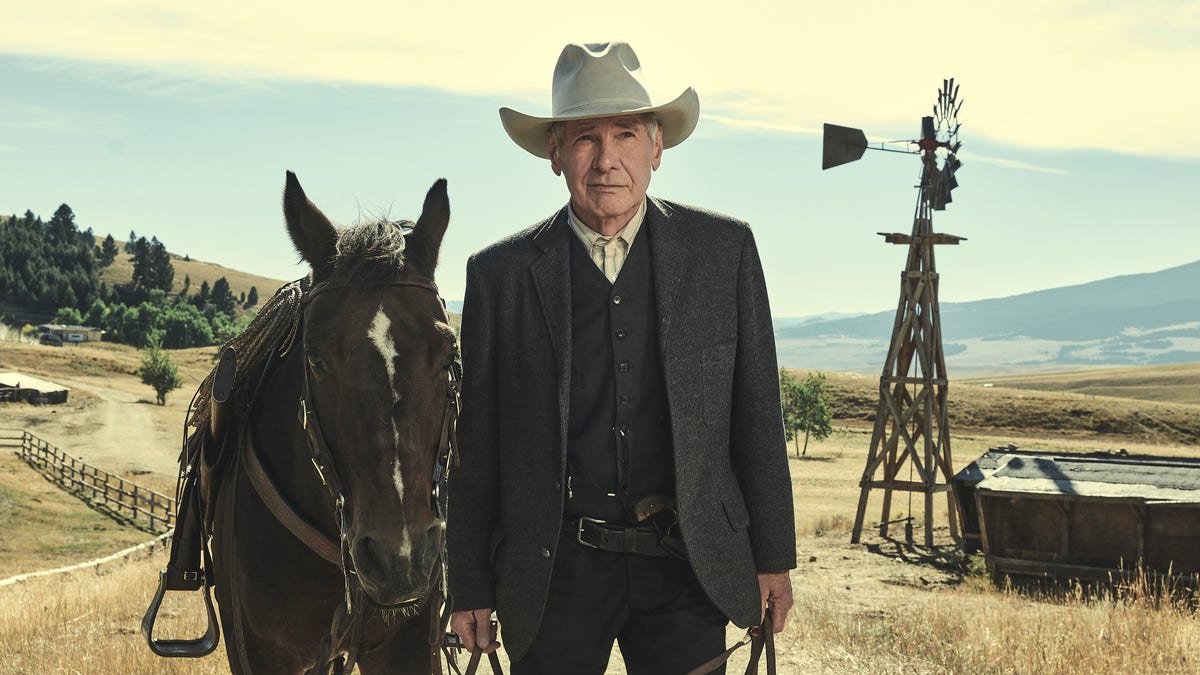 Harrison Ford walks with a horse in 