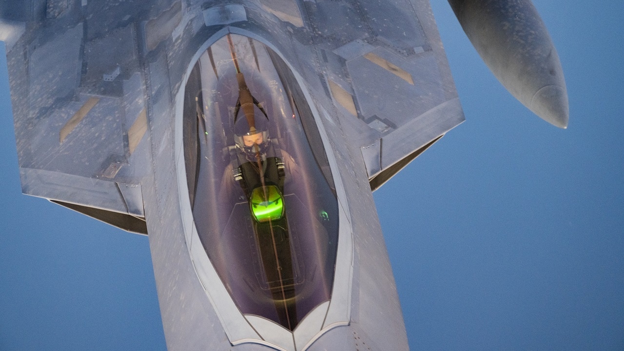 A U.S. Air Force F-22 Raptor receives fuel from a U.S. Air Force KC-135 Stratotanker assigned to the 340th Expeditionary Air Refueling Squadron, above the U.S. Central Command area of responsibility, March 14, 2022. The F-22 Raptor is a fifth-generation aircraft that combines stealth, supercruise, maneuverability, integrated avionics, and is designed to project air dominance, rapidly and at great distances, and deter regional aggressors while deployed in the USCENTCOM AOR. (U.S. Air Force photo by Staff Sgt. Frank Rohrig)