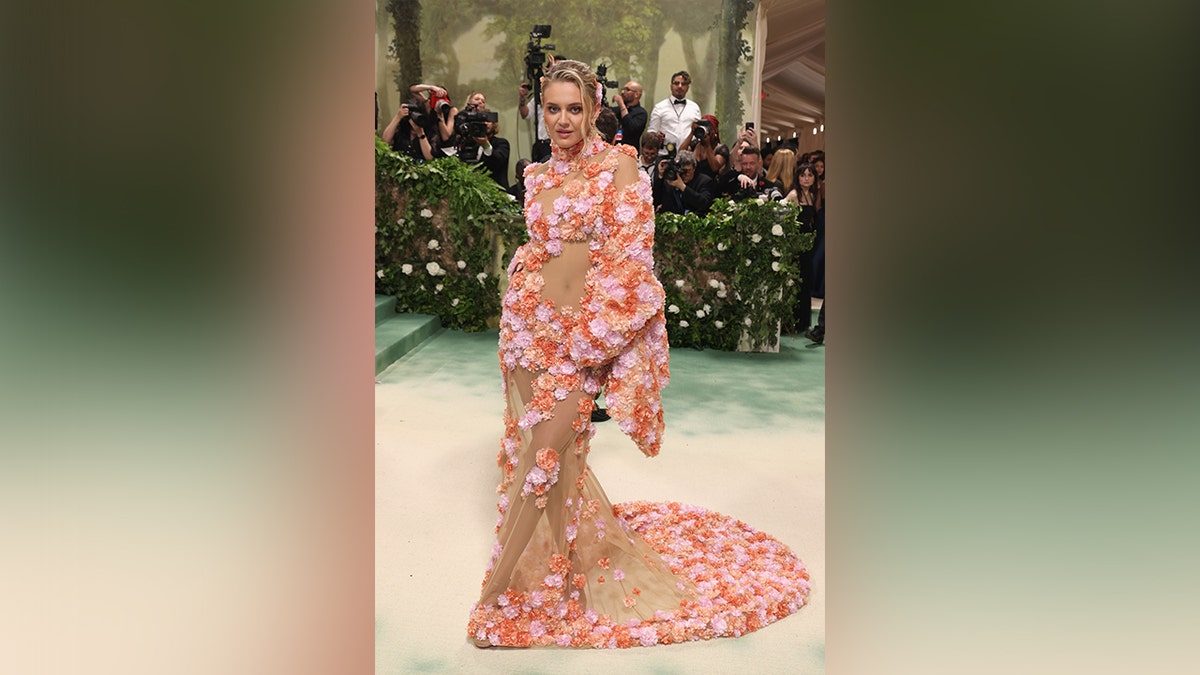 Kelsey Ballerini wore a sheer dress with floral designs on the Met Gala red carpet.