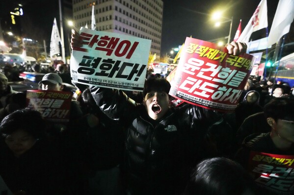 A man shouts to demand South Korean President Yoon Suk Yeol to step down in front of the National Assembly in Seoul, South Korea, Wednesday, Dec. 4, 2024. (AP Photo/Ahn Young-joon)