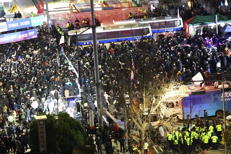 People gather to demand South Korean President Yoon Suk Yeol step down in front of the National Assembly in Seoul, South Korea, Wednesday, Dec. 4, 2024. (Kim Do-hoon/Yonhap via AP)