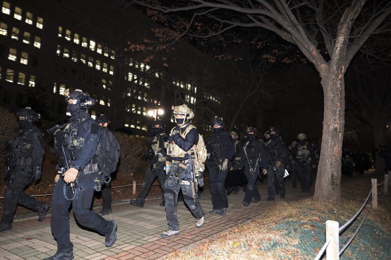 South Korean martial law soldiers leave the National Assembly in Seoul, South Korea, Wednesday, Dec. 4, 2024. (Kim Ju-sung/Yonhap via AP)