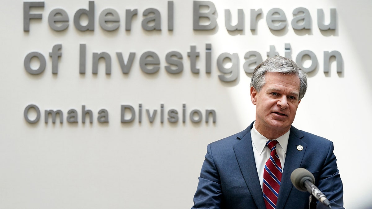 Christopher Wray in front of FBI sign in Omaha, Nebraska