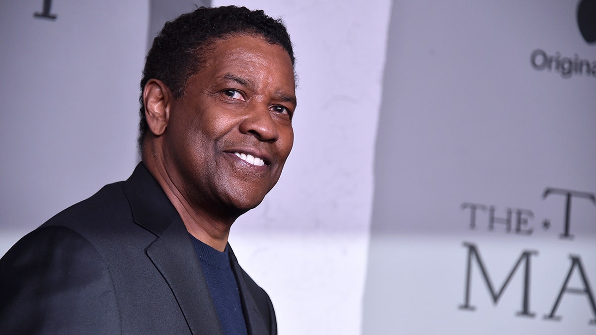 Denzel Washington smiles at the camera