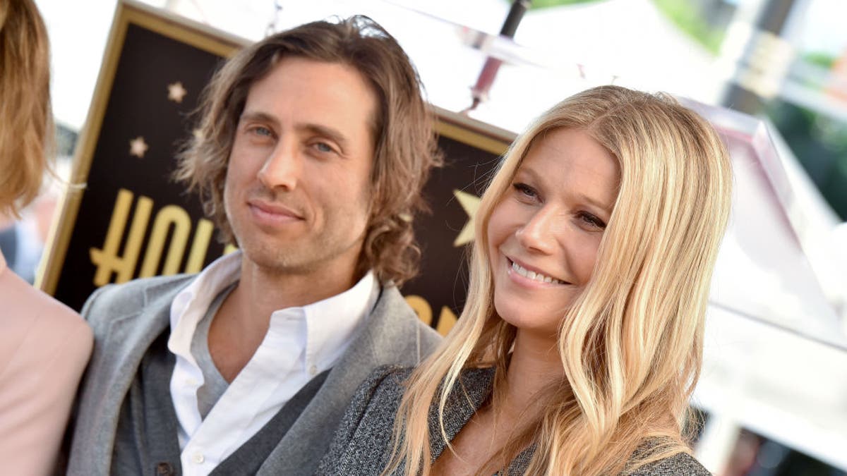 gwyneth paltrow brad falchuk smile wearing matching grey outfits