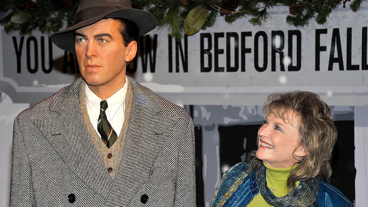 Karolyn Grimes smiling at a James Sewart wax figure