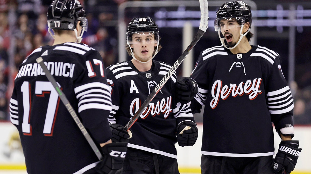 New Jersey Devils center Jack Hughes (86) is congratulated by teammates after scoring his second goal of the third period against the New York Rangers during an NHL hockey game on Tuesday, March 22, 2022, in Newark, N.J. The Devils won 7-4.