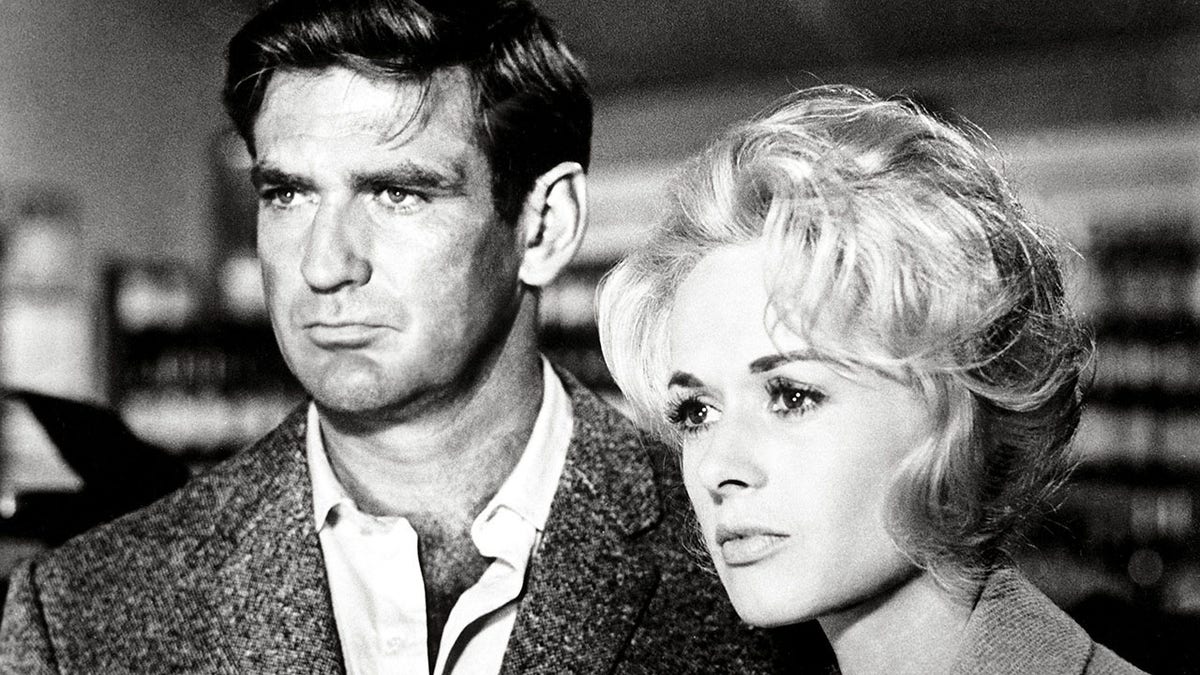 A close-up of Rod Taylor and Tippi Hedren looking pensive in 