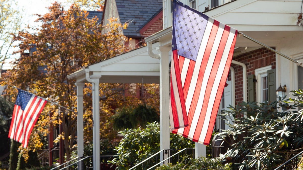 American flags flying outside homes