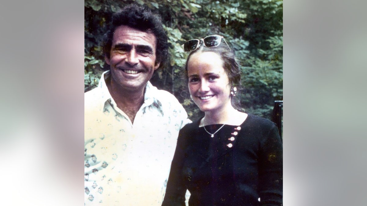 Anne Serling wearing black and smiling with her father who is wearing white.