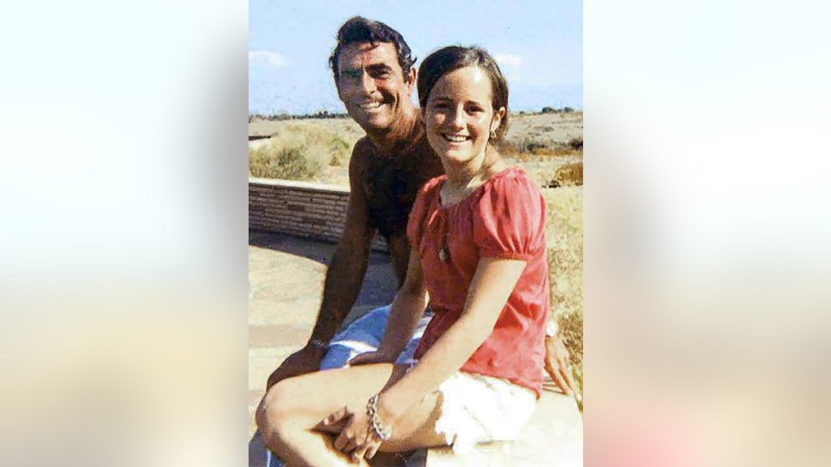 Anne Serling in a coral blouse and white shorts with her father Rod Serling in beach shorts.