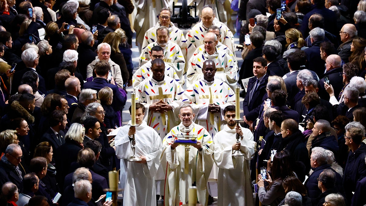 priests and clergy arrive at Mass