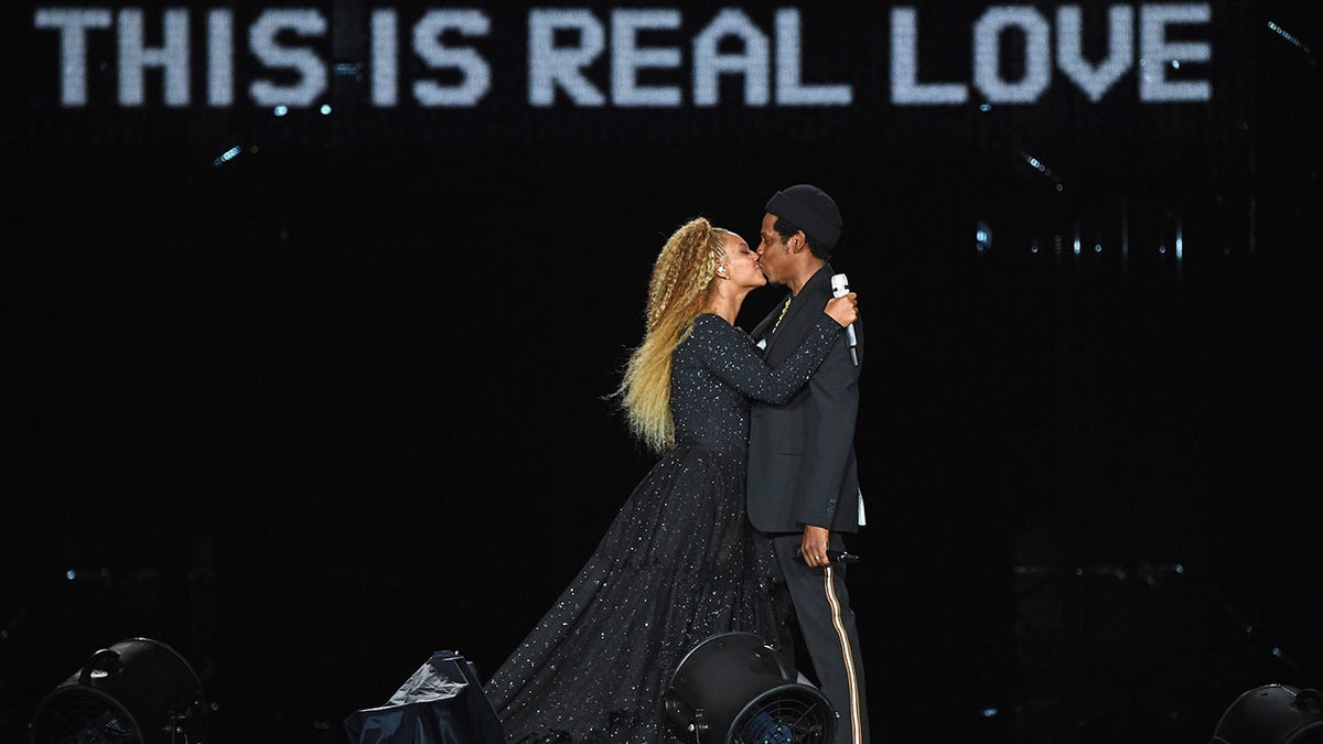 Jay-Z kisses wife Beyonce on stage