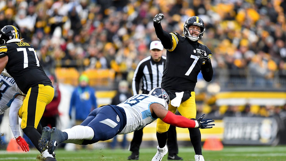 Ben Roethlisberger #7 of the Pittsburgh Steelers  delivers a pass over a roughing the passer penalty by Jeffery Simmons #98 of the Tennessee Titans in the fourth quarter of the game at Heinz Field on Dec. 19, 2021 in Pittsburgh, Pennsylvania.