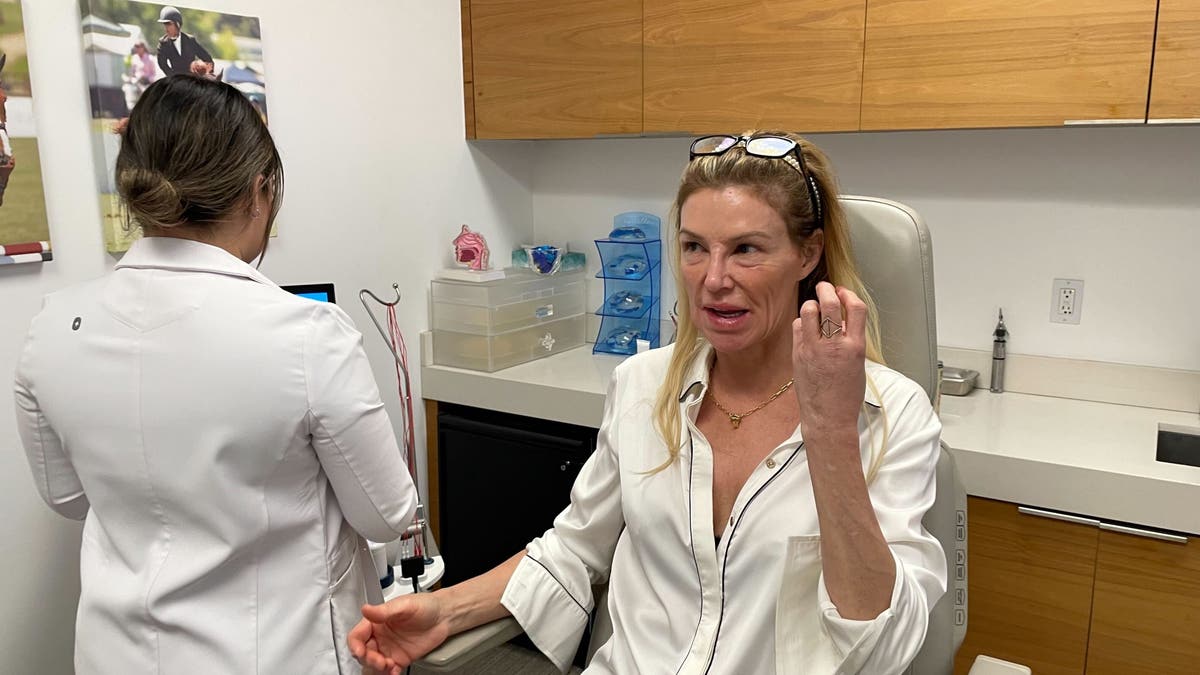 Brandi Glanville sits in doctors office