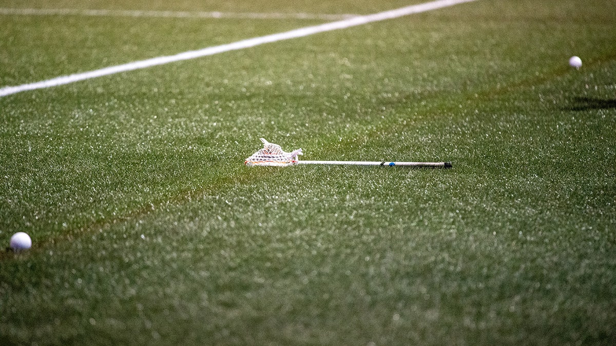 A lacrosse stick on the ground