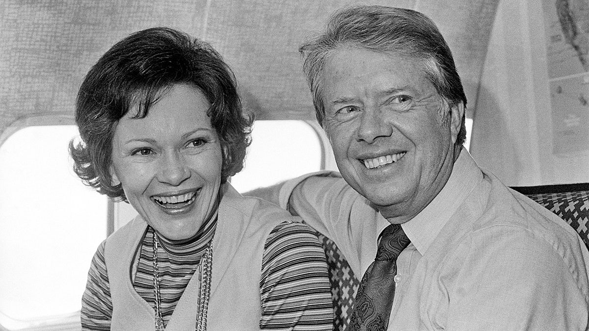 Jimmy Carter, Democratic presidential candidate, and his wife, Rosalynn, share a moment aboard his campaign plane