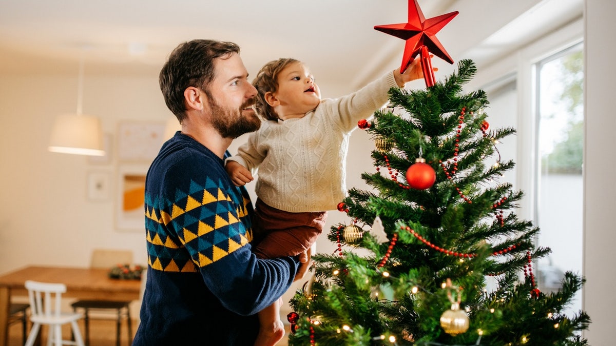 Father and son decorating a Christmas tree