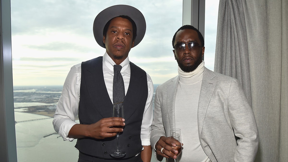 Rappers Jay-Z and Diddy wear grey ensembles at party