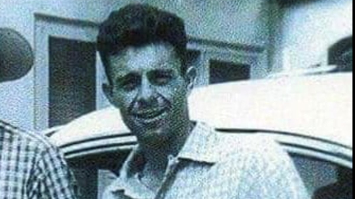 Close-up of Carl Switzer smiling in a plaid shirt.