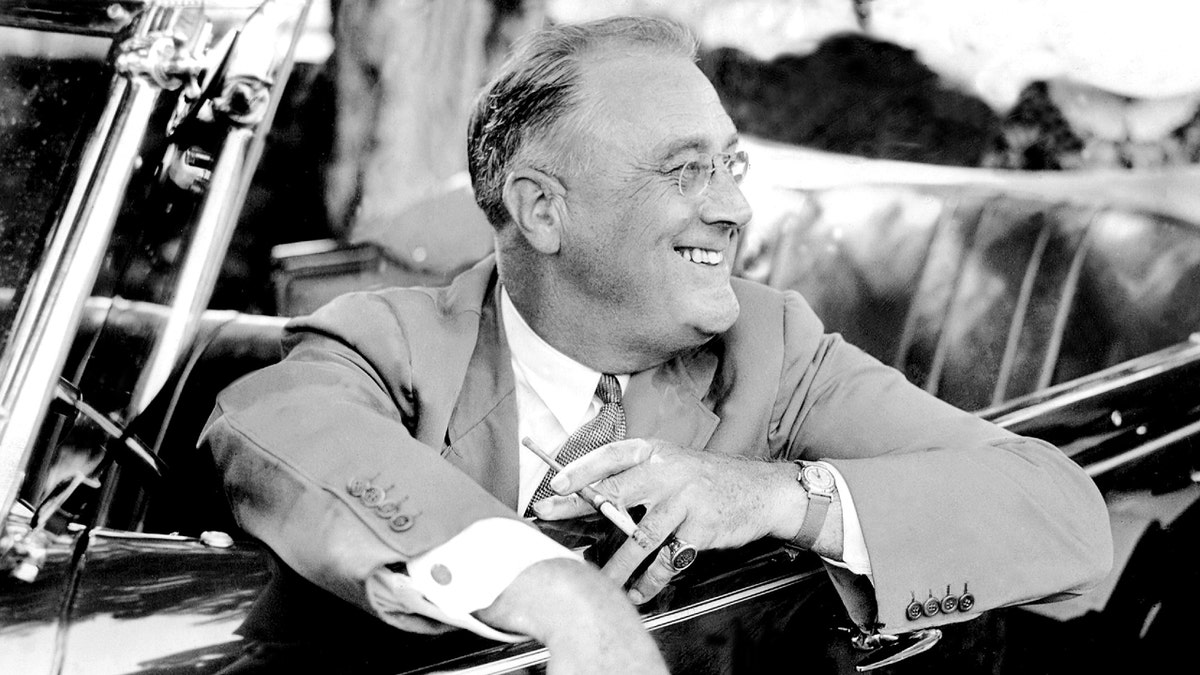 Franklin D. Roosevelt in a car smiling