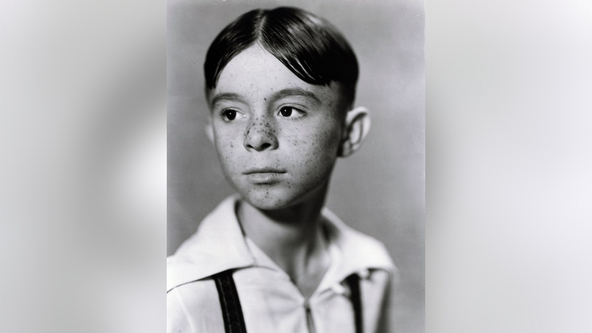 A close-up of Carl Switzer as Alfalfa wearing a white shirt and suspenders.