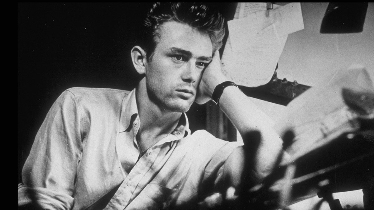 James Dean surrounded by paperwork.