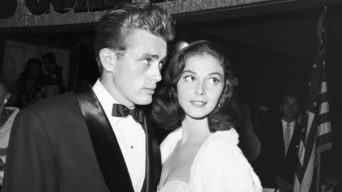 James Dean in a tux posing alongside Pier Angeli in a dress and white shawl