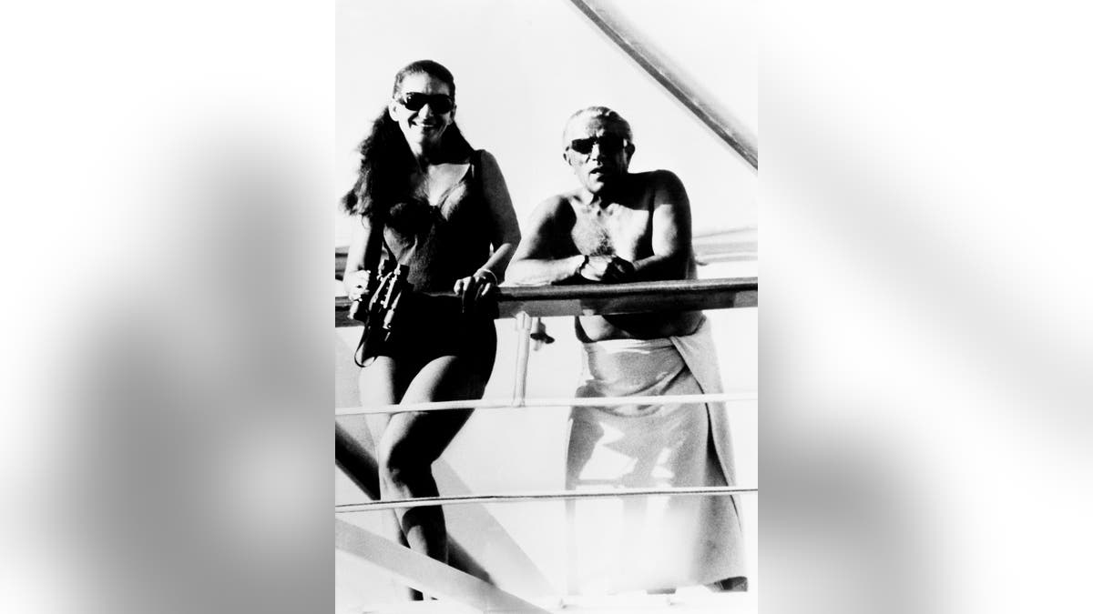 Maria Callas smiling and wearing a swimsuit with her lover Onassis