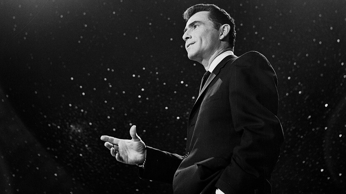 Rod Serling talking to an audience in a dark suit