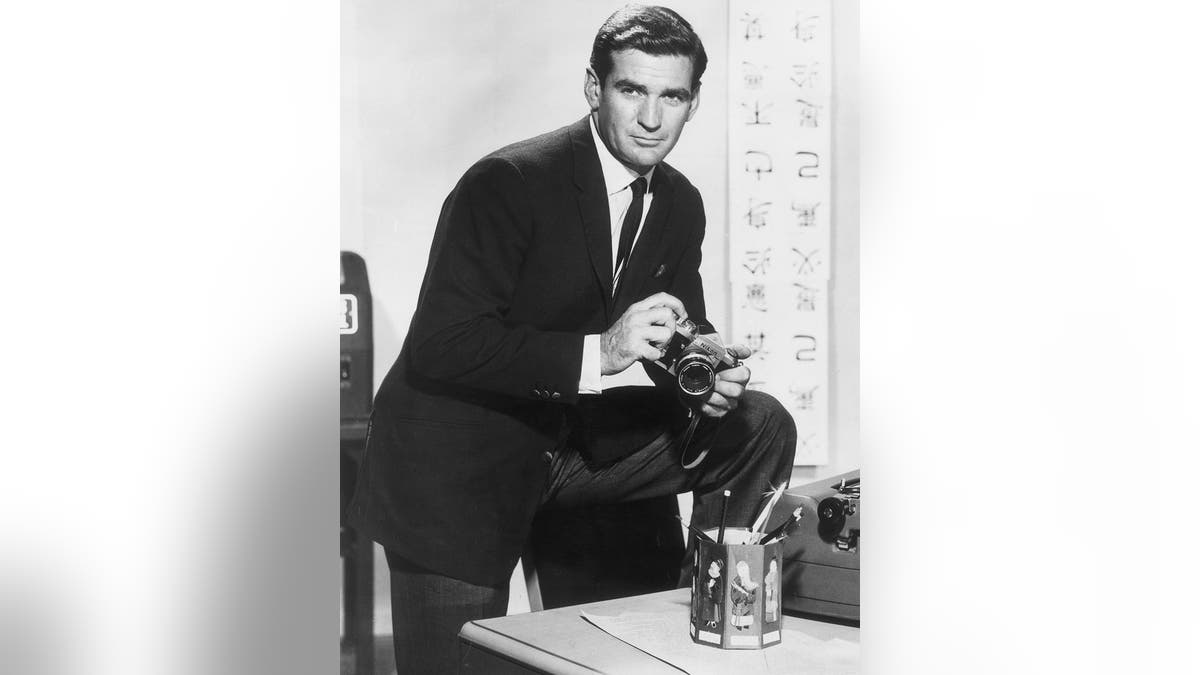 Rod Taylor holding a camera.