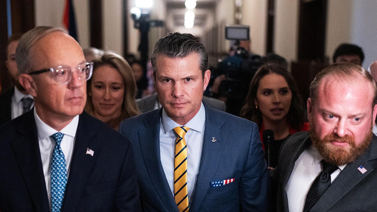 Pete Hegseth, center, President-elect Donald Trump's nominee to be Defense secretary, makes his way to a meeting with Sen. Ted Budd, R-N.C., in the Russell Building on Tuesday, Dec. 3, 2024.