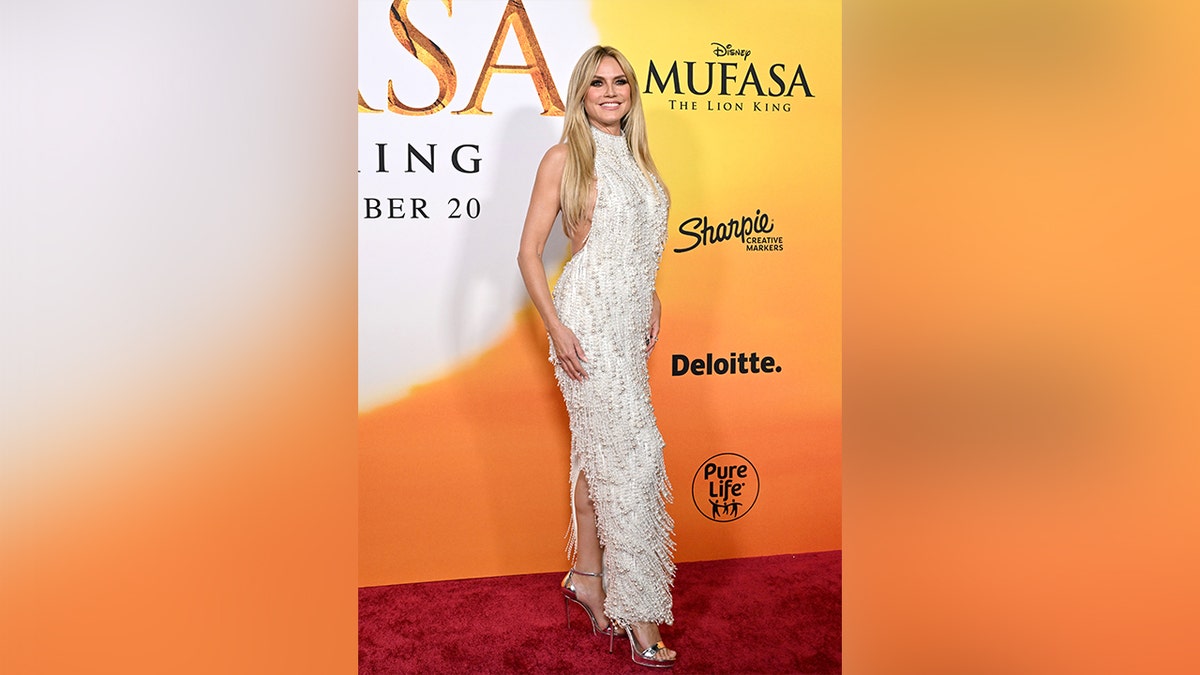 Heidi Klum wore a shiny beaded white gown with fringe to the premiere of 