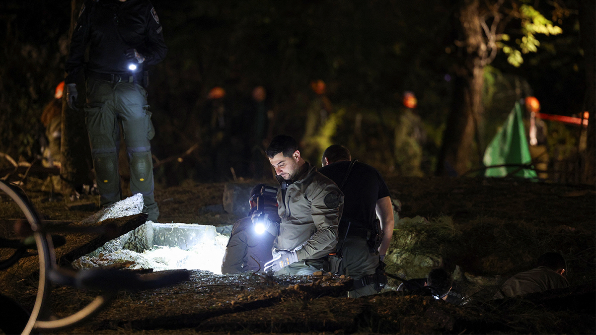 Israeli emergency services work at the scene of a missile strike