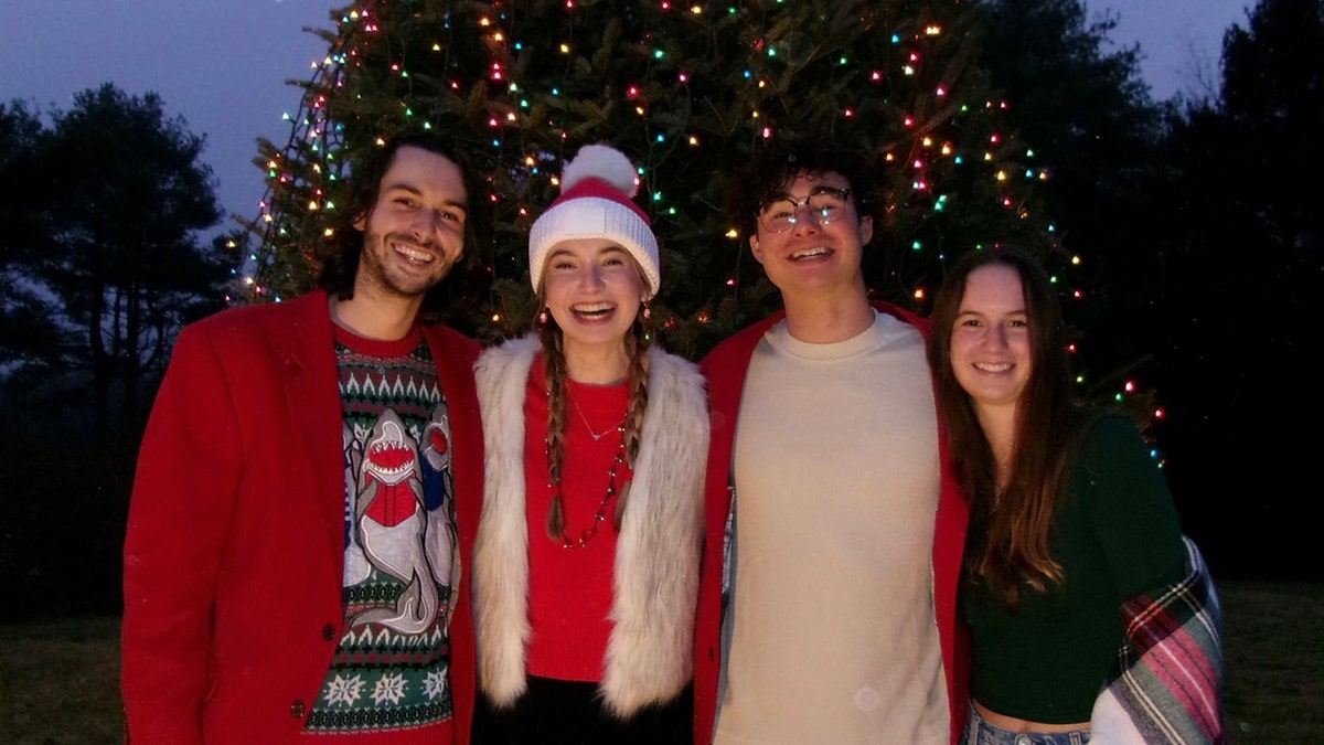 Group at Christmas in front of a tree.