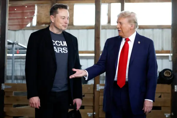 Republican presidential nominee former President Donald Trump offers his hand to Tesla founder Elon Musk backstage during a campaign rally at the Butler Farm Show grounds, in Butler, Pa., on Oct. 5, 2024. (Anna Moneymaker/Getty Images)