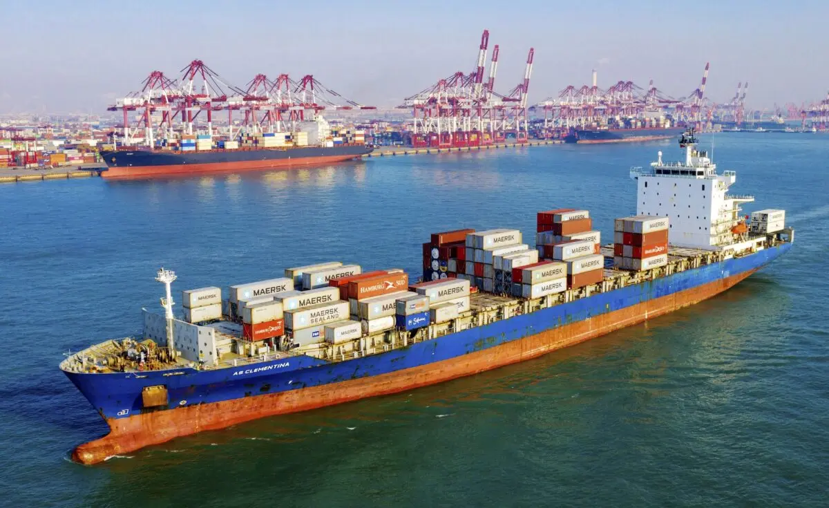 A container vessel moves past the port in Qingdao in eastern China's Shandong Province on Jan. 14, 2020. (Chinatopix Via AP)