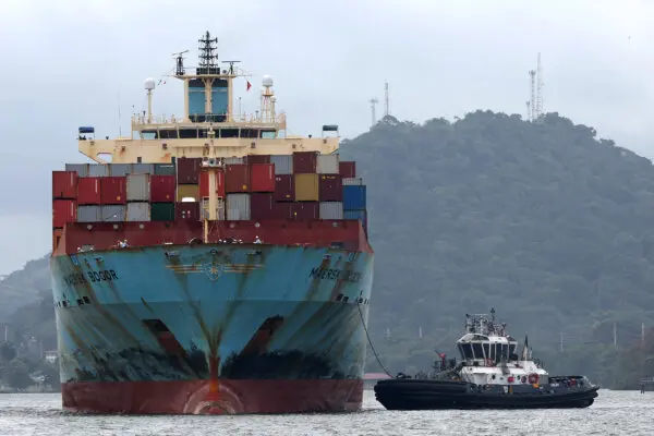 The container ship Maersk Bogor is guided by a tugboat as it prepares to enter the Miraflores locks while transiting the Panama Canal in Panama City, Panama, on Sept. 22, 2023. (Justin Sullivan/Getty Images)