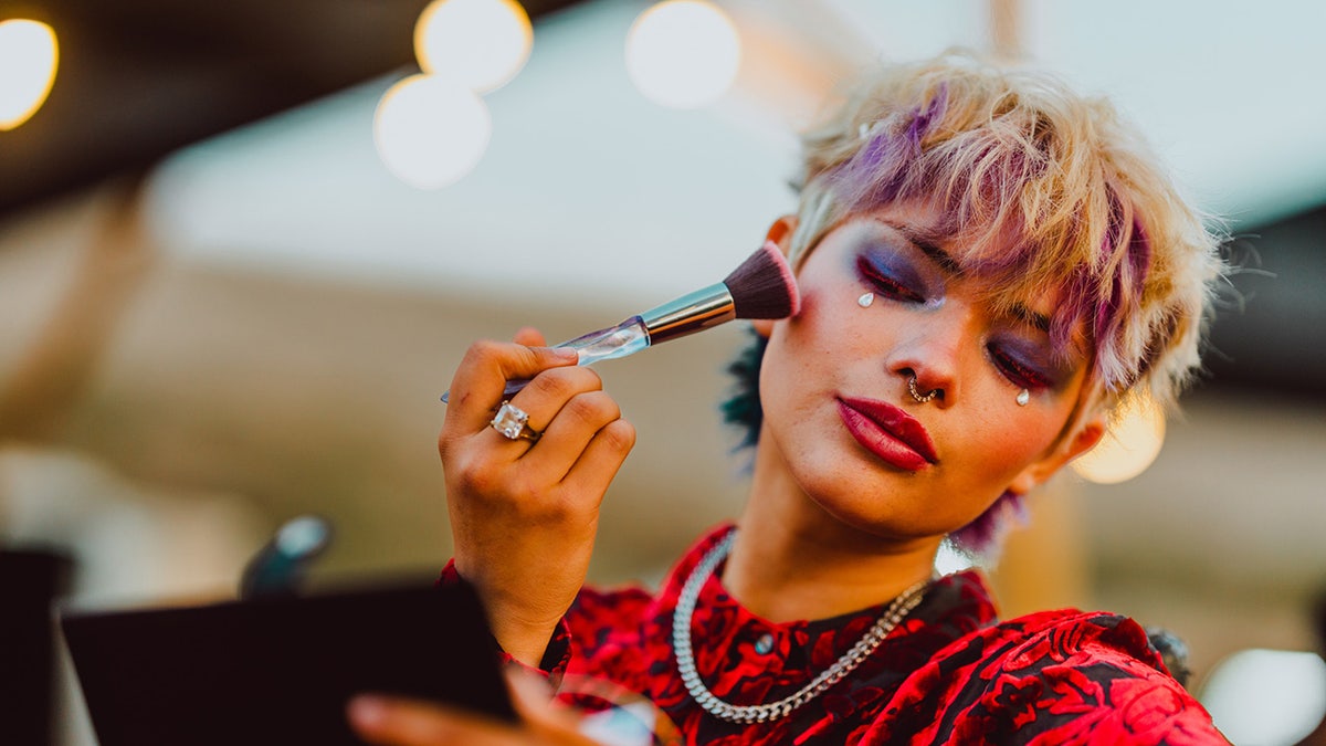 Woman putting makeup on