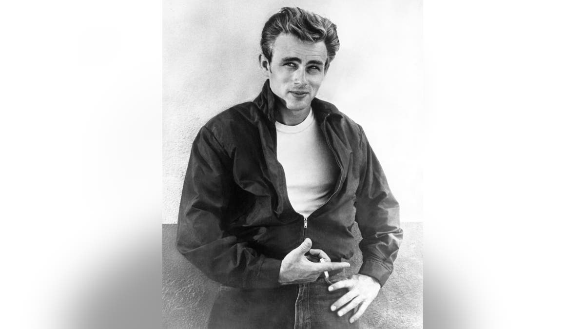 James Dean posing in a jacket and white shirt.