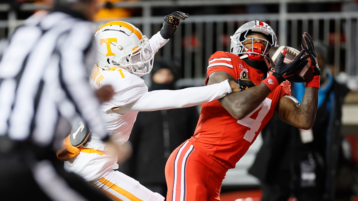 Jeremiah Smith makes a catch over Rickey Gibson