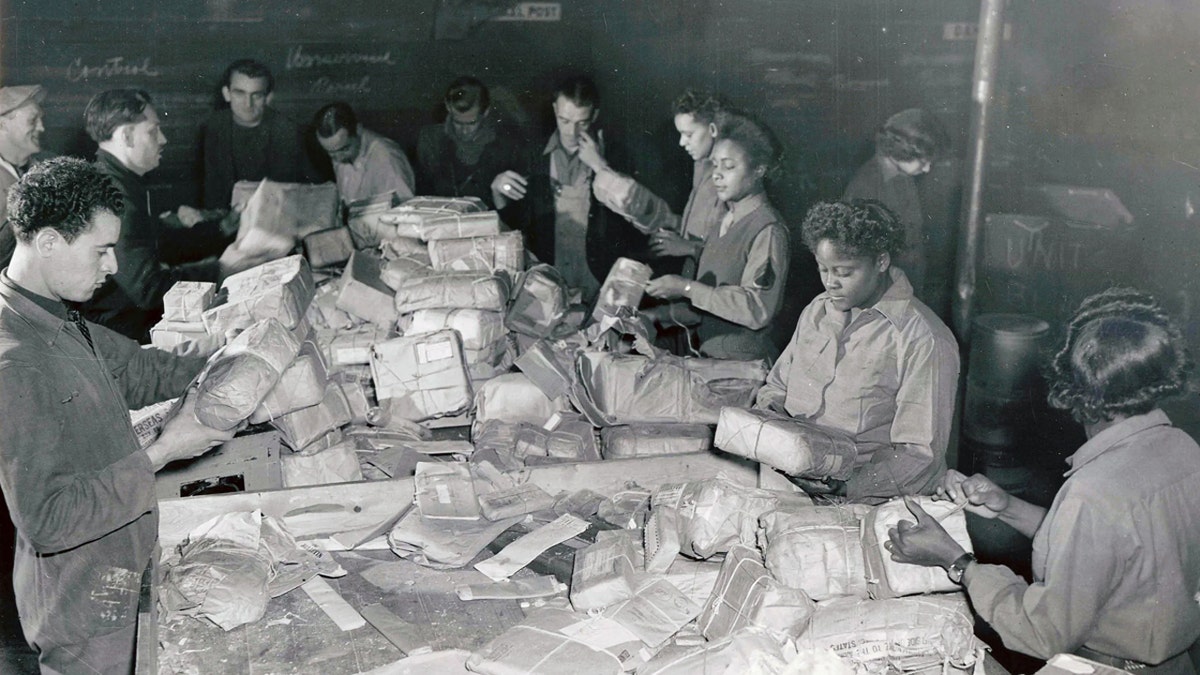 A National Archives photograph shows the 6888th postal battalion sorting mail.