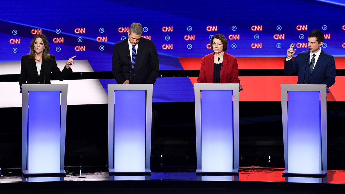 Marianne Williamson and others at a Democratic presidential primary debate in 2019