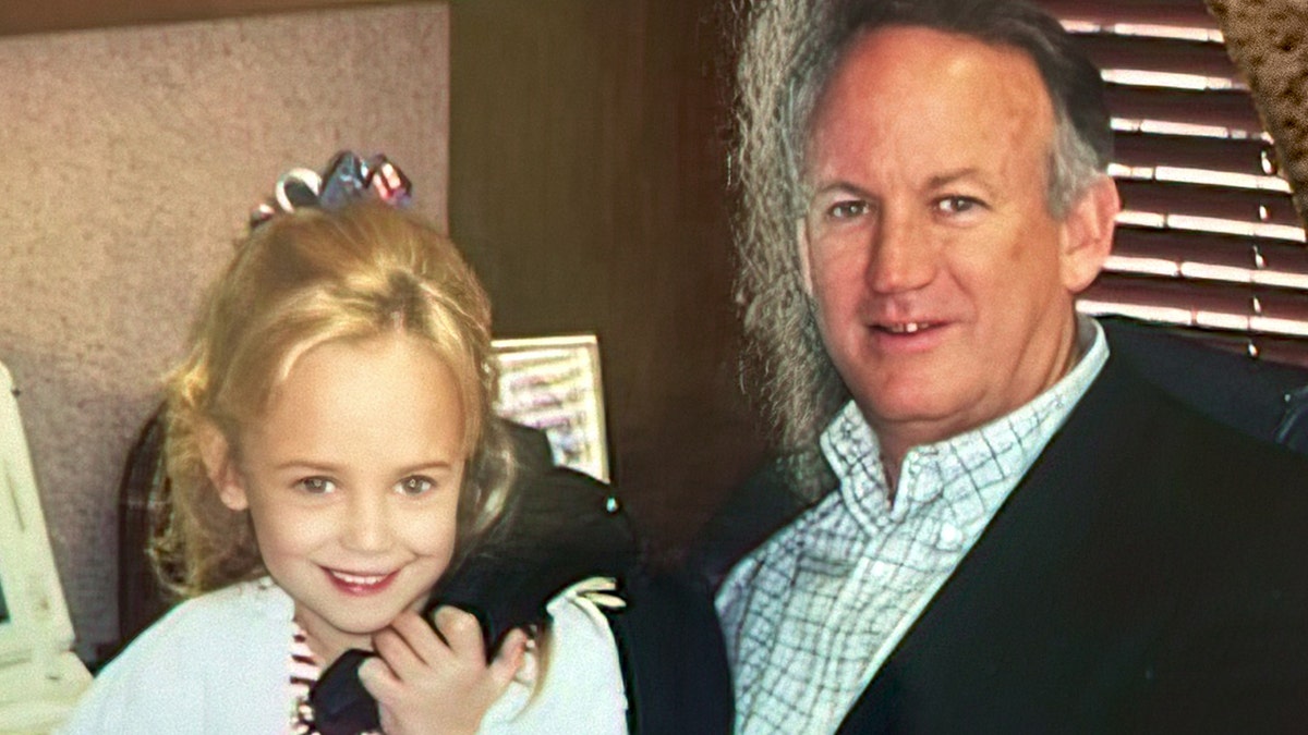 Close-up of JonBenet Ramsey and John Ramsey together and smiling